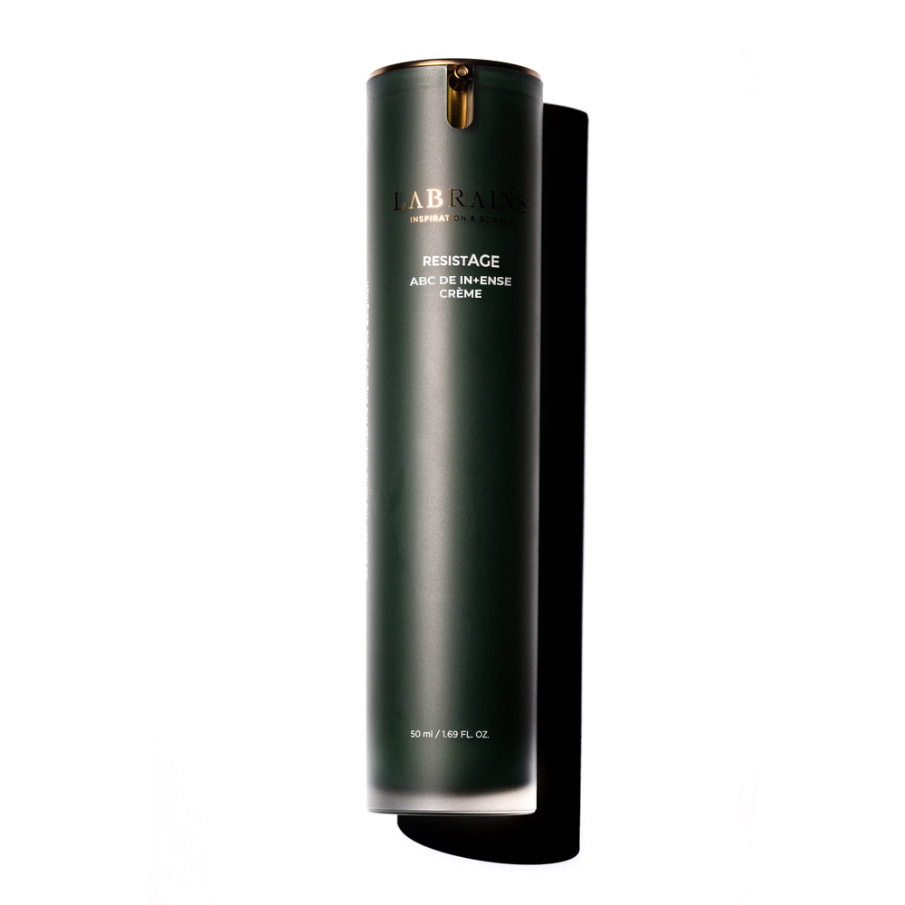 A green cylindrical bottle of LABRANS abc de intense creme with a white and gold label, displayed against a white background.