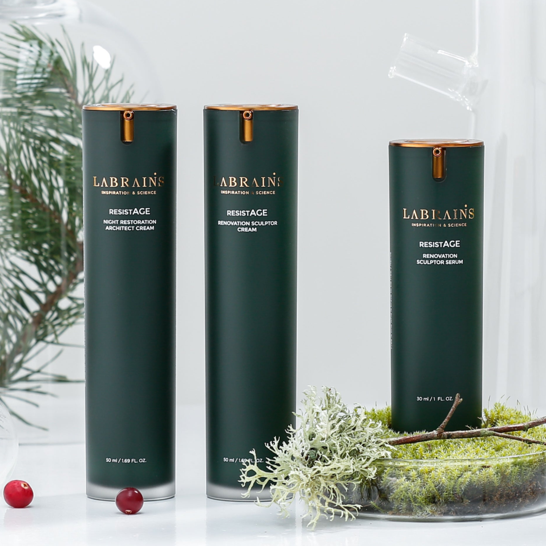 three labrains skincare products from the resistage line on light background with moss and pine decorations