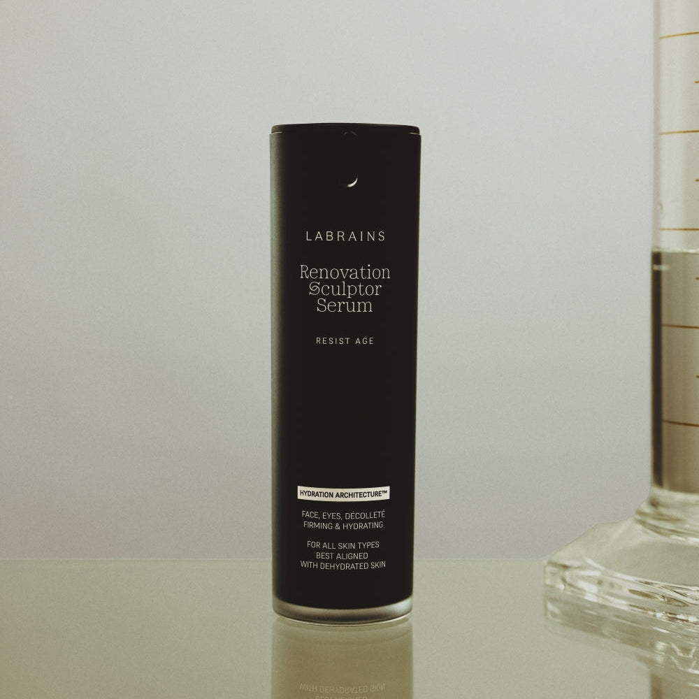 LABRAINS Renovation Sculptor Serum on a reflective surface with a neutral background