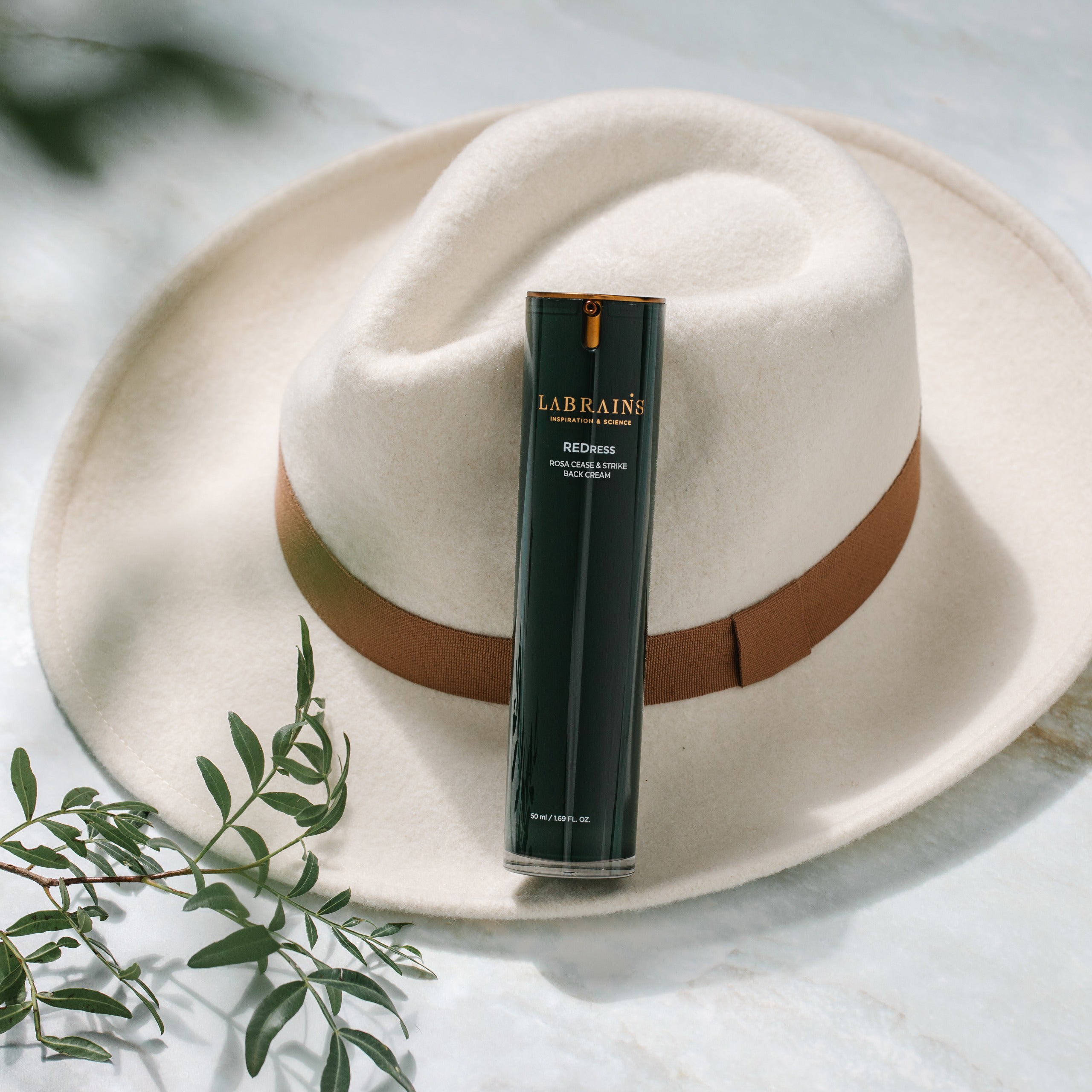 labrains skincare rosa cease & strike back cream bottle on a white hat