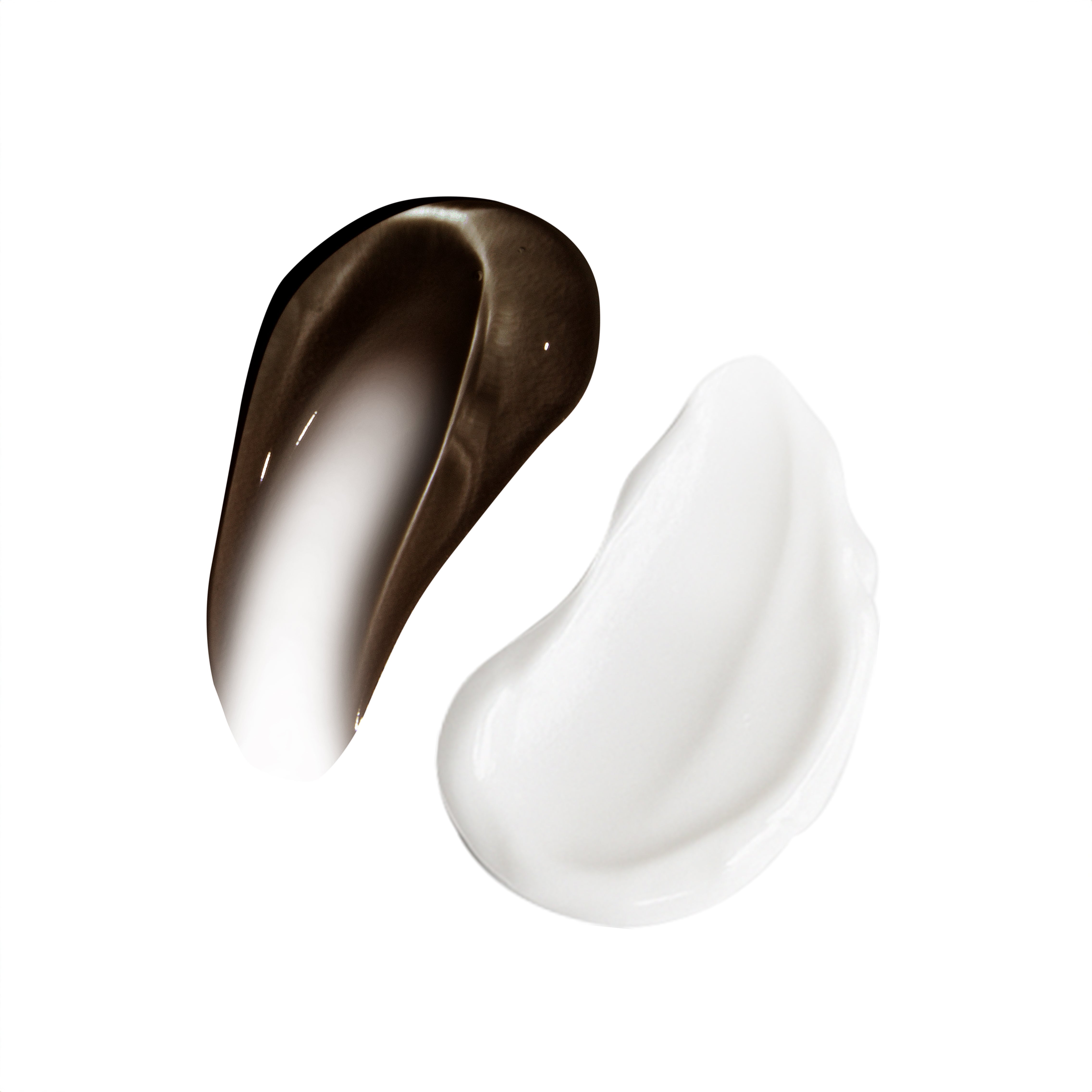 Two drops of skincare products, one brown gel and one white cream, on a white background