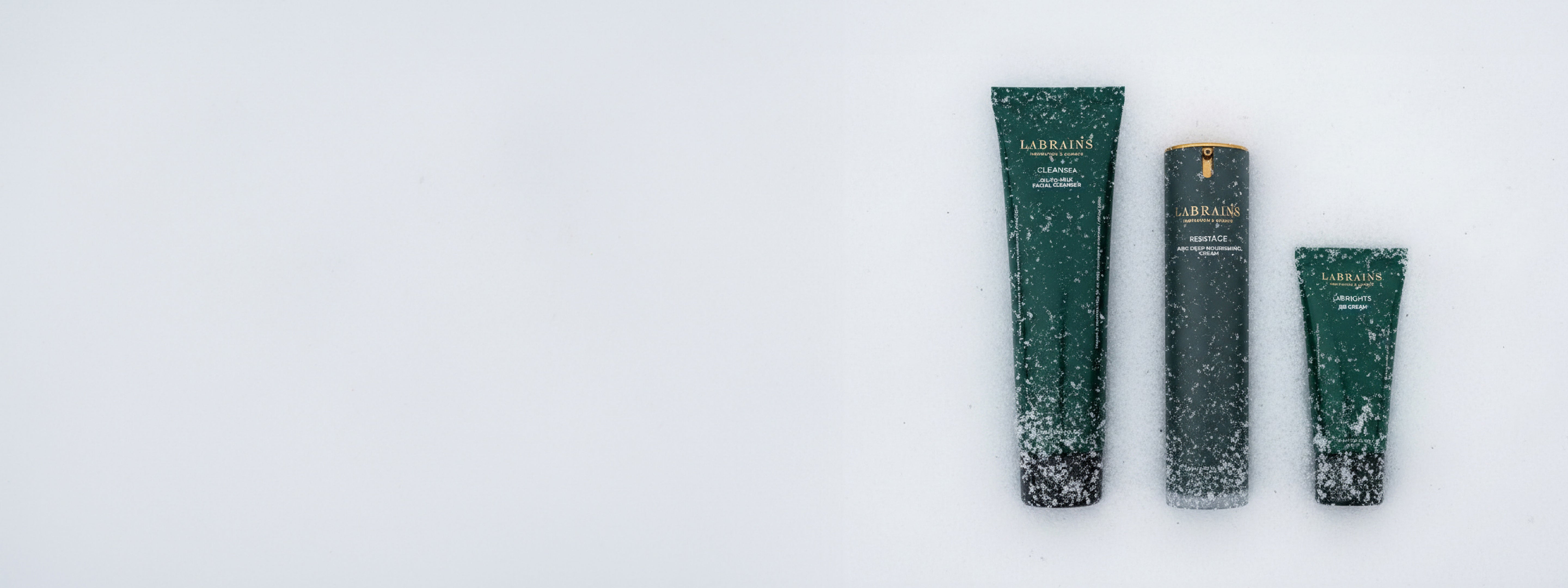 Three LABRAINS skincare products in snow