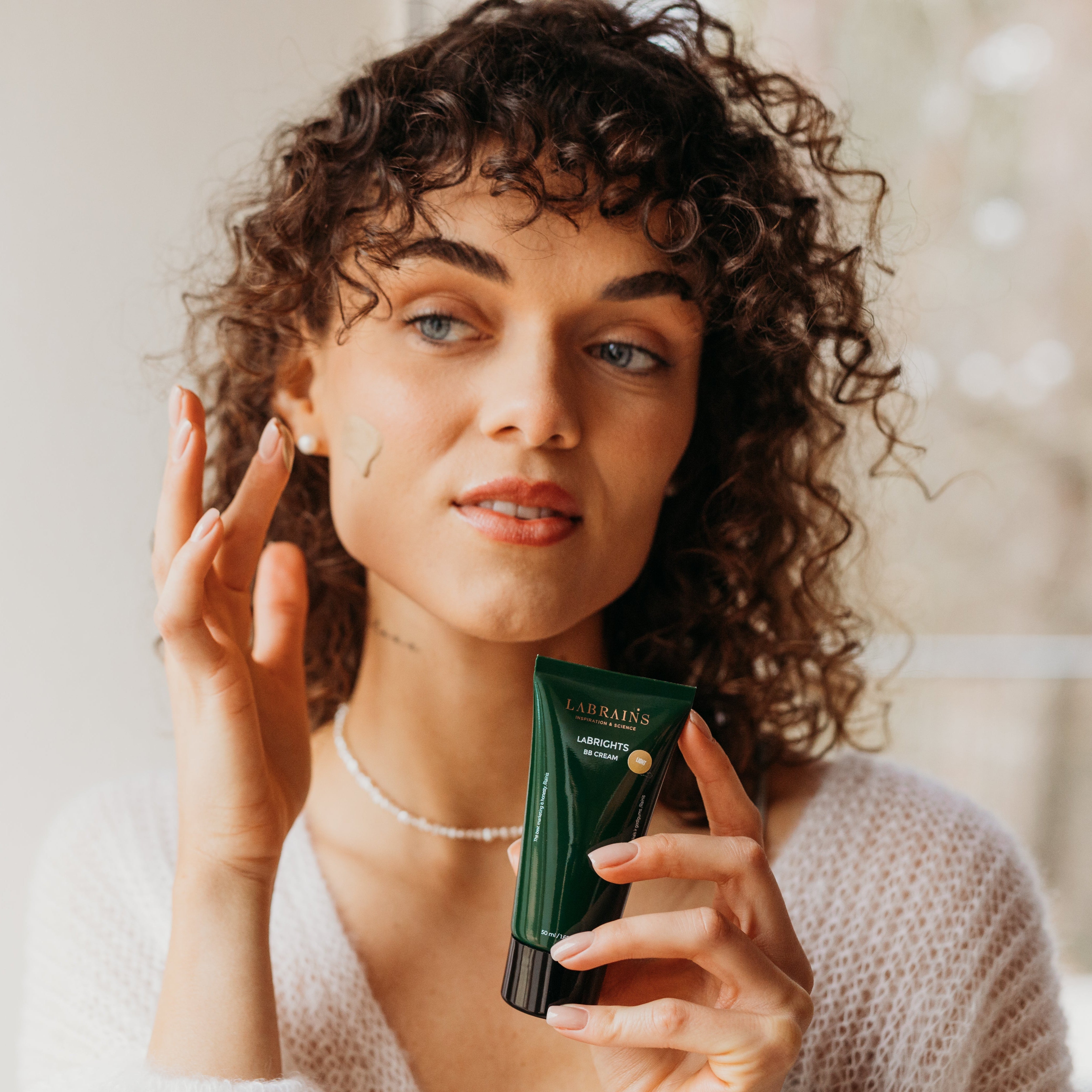 woman applying labrains bb cream 